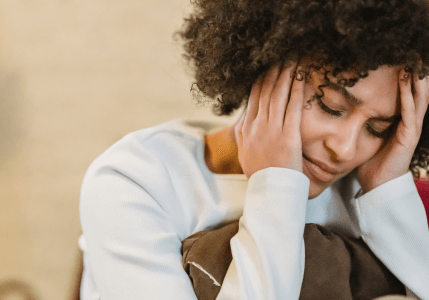 bridge-centre-derby-stress-anxiety Woman holding her head in her hands
